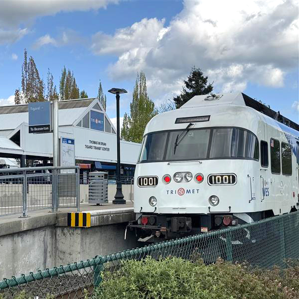 "The WES light rail train sits at the Tigard Transit Center waiting for passengers to board.""