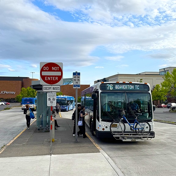 "a bus picking up passengers at Washington Square Transit Center"